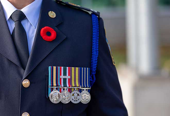 poppy pinned to a service member also displaying medals