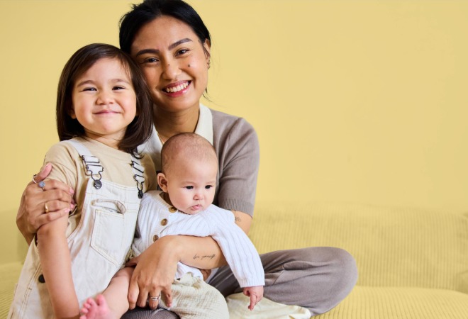 Mother hugging two children
