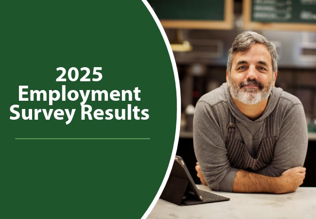 A man standing at a service counter with a tablet.