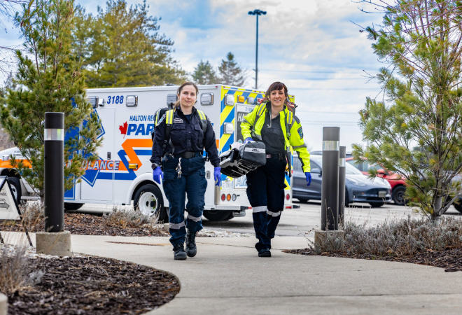 Paramedics walking away from an ambulance.