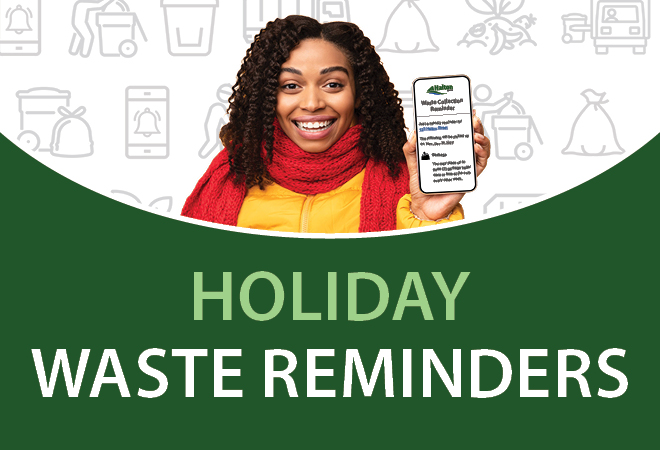 A young woman holding a cell phone that displays the waste calendar tool.