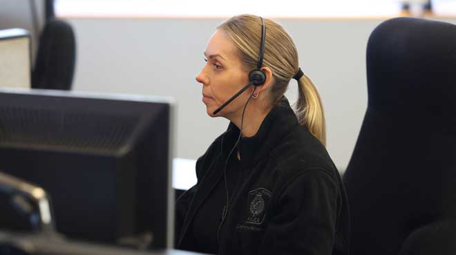Call center employee answering the phone through a headset in an office setting