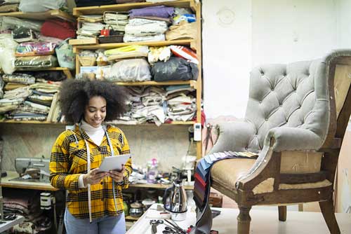 woman re-upholstering a chair