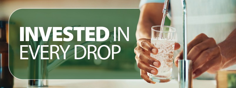 A person filling a drinking glass with water.