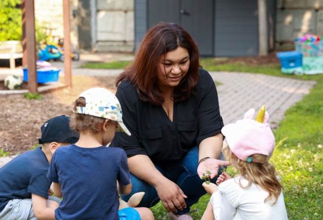 Early childhood educator outdoors with children