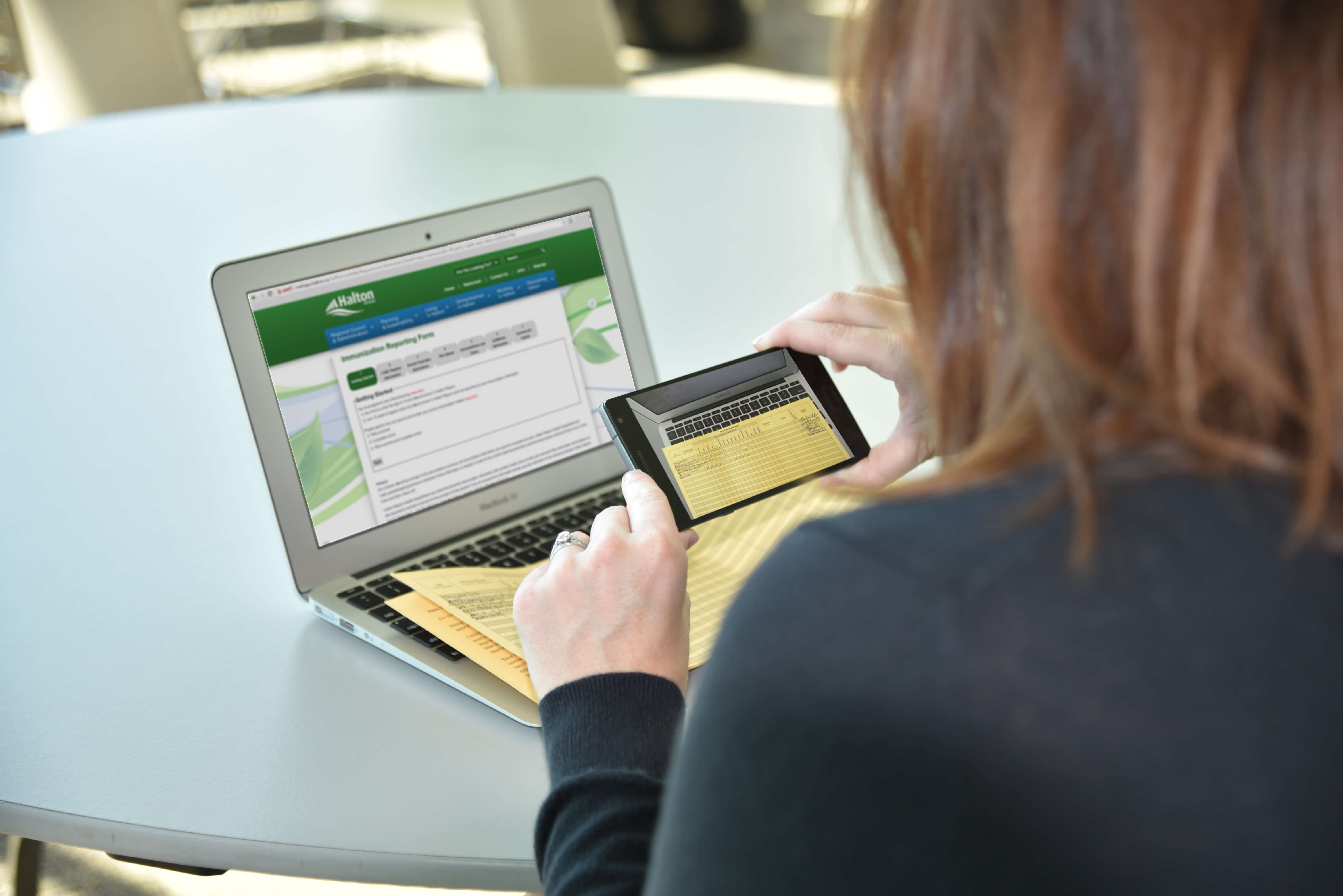 Resident submitting immunization record through mobile device