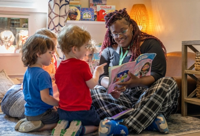 An Early Childhood Educator reads to children at a Regional child care centre