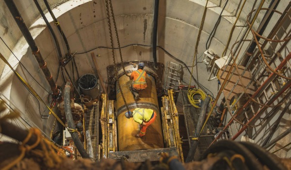 A construction worker working in an underground tunnel.