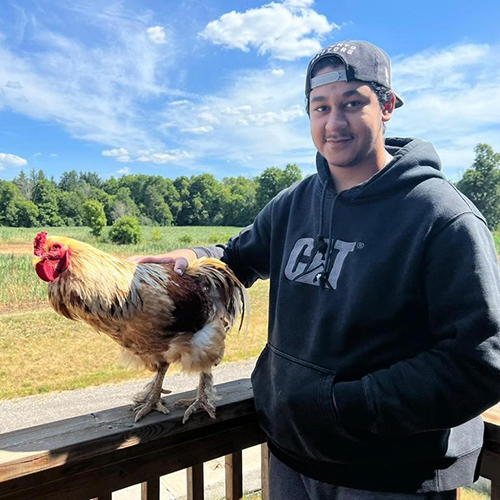 Photo of Abdullah Ahmed with a chicken