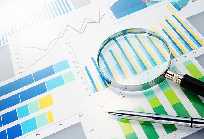 Image of graphs and charts with magnifying glass