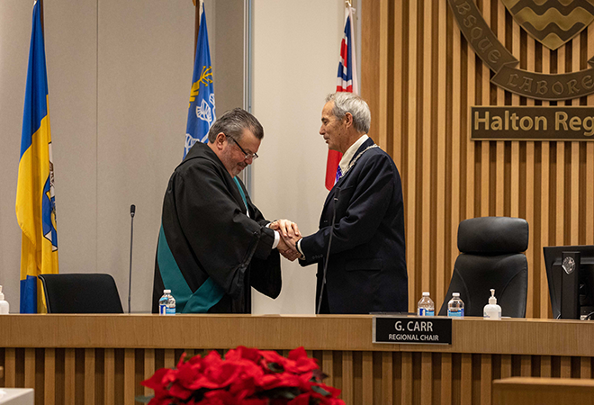 Halton Regional Chair Gary Carr receives the Official Chain of Office from His Worship, Justice of the Peace, Mark J. Curtis.