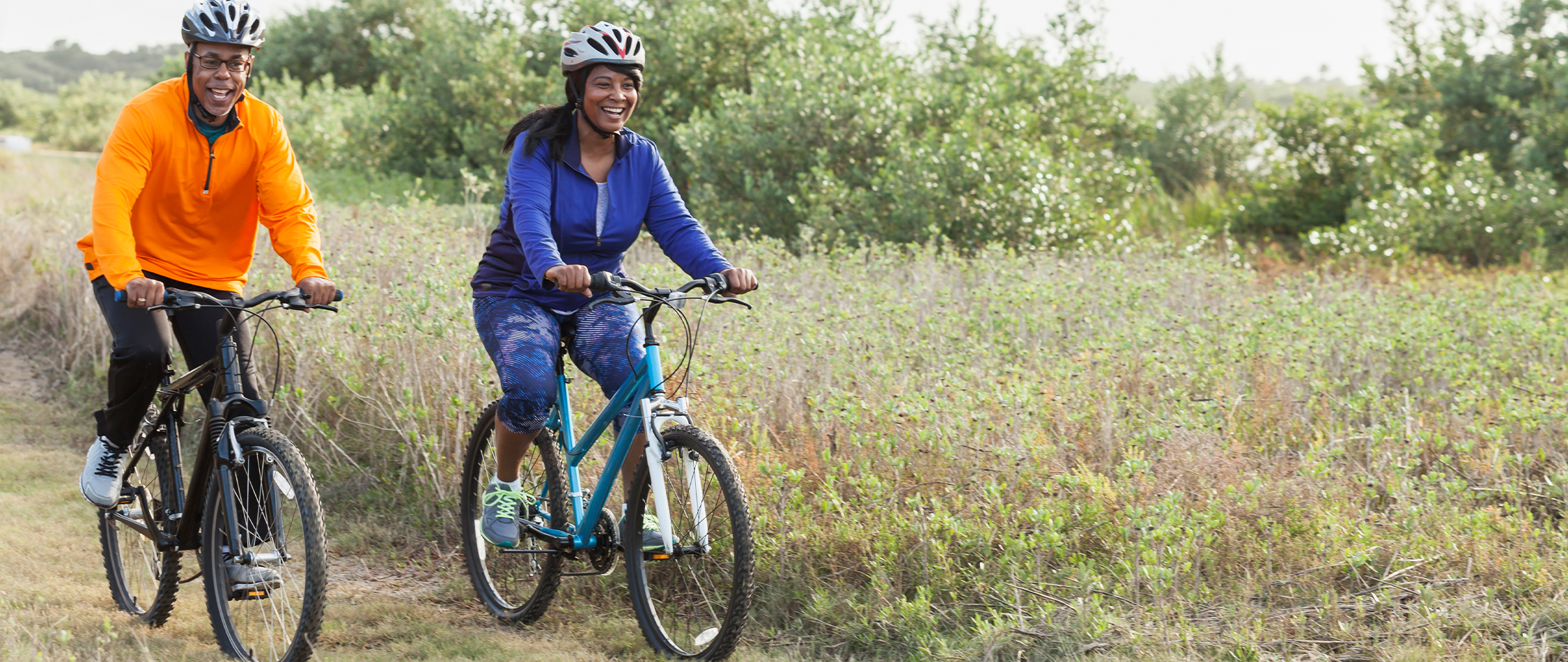Two people riding bicycles on a trail 