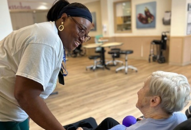 A nurse supporting a resident.