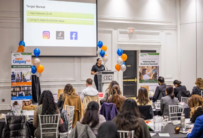 Participant standing on stage, presenting to the crowd.