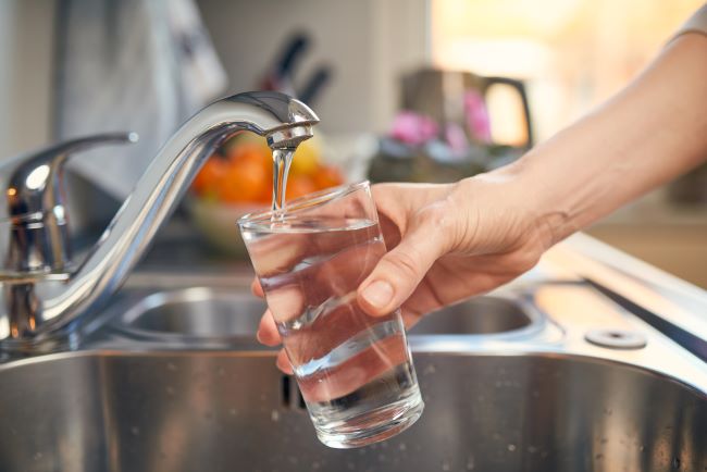 Filling a glass with high-quality drinking water from the tap