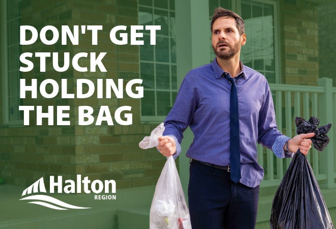 man stuck holding bags of garbage